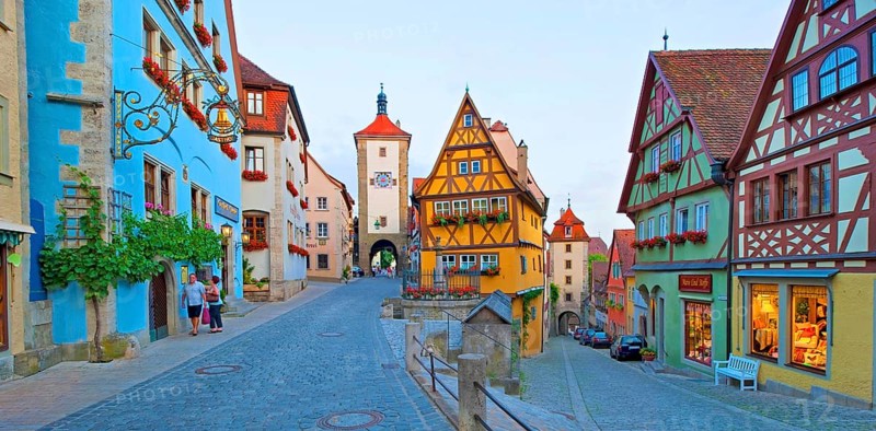 Town view of Rothenburg ob der Tauber in the evening at blue hour, in the foreground the Plönlein Platz, the Kobolzell tower on the right and the Siebersturm on the left, people are unrecognizable, Bavaria, Germany, Europe
