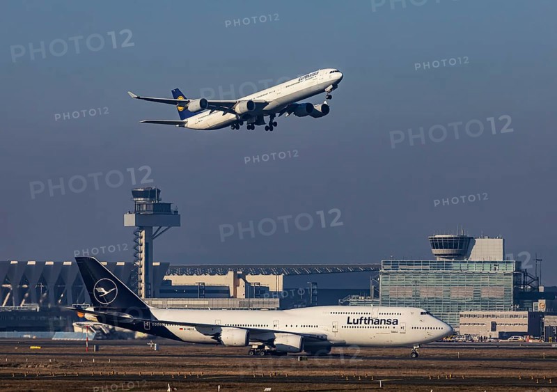 Aircraft taking off at Frankfurt Airport, Fraport Airport with tower. D-AIHX, LUFTHANSA, AIRBUS A340-642. D-ABYA, LUFTHANSA, BOEING 747-830, Frankfurt am Main, Hesse, Germany, Europe