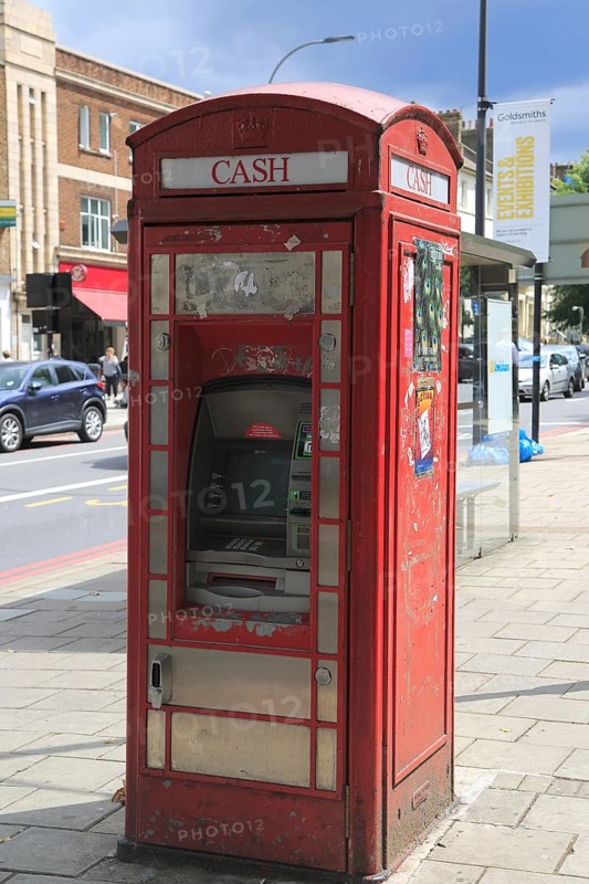Traditional red telephone kiosk converted to ATM cash machine, New Cross, Deptford, south London, England, UK