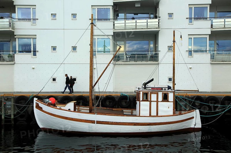 Traditional wooden boat outside modern housing apartments, Molde, Romsdal county, Norway, Europe