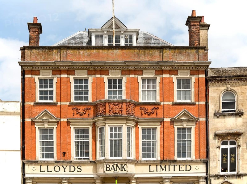 Red brick facade exterior of Lloyds Bank Limited, Devizes, Wiltshire, England, UK