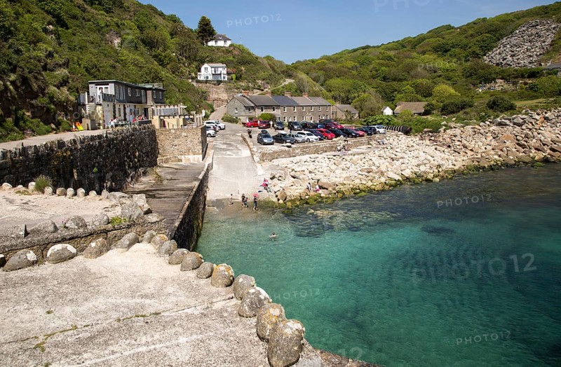 Warm summer sunshine calm water, Lamorna Cove, Cornwall, England, UK