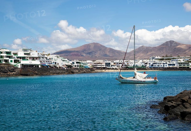 Yacht arriving in harbour at Playa Blanca, Lanzarote, Canary Islands, Spain, Europe