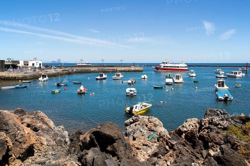 Harbour and ferry boat in the fishing village of Orzola, Lanzarote, Canary Islands, Spain, Europe
