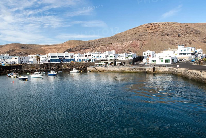 Harbour and white houses in the fishing village of Orzola, Lanzarote, Canary Islands, Spain, Europe