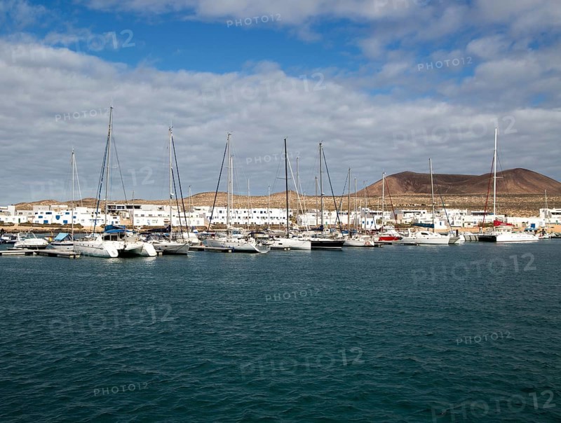 Yachts at moorings Caleta de Sebo harbour and village, La Isla Graciosa, Lanzarote, Canary Islands, Spain, Europe