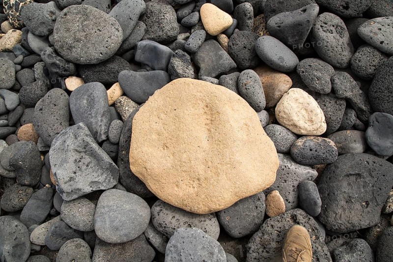 Close up of rounded beach pebbles looking down from above, Isla La Graciosa, Lanzarote, Canary Islands, Spain, Europe