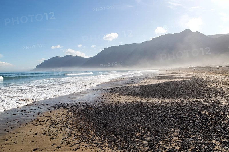 Atlantic Ocean coast beach and waves with morning sea mist, Caleta de Famara, Lanzarote, Canary islands, Spain, Europe