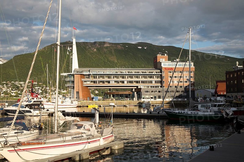 Modern architecture of Scandic Hotel and boats in harbour, city centre of Tromso, Norway, Europe
