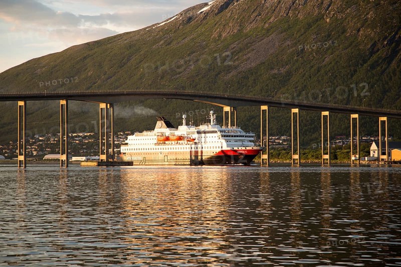 Hurtigruten ferry ship Nordlys approaching Tromso passing under cantilever bridge, Norway, Europe