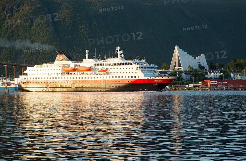 Hurtigruten ferry ship Nordlys approaching Tromso, Norway past the Arctic cathedral