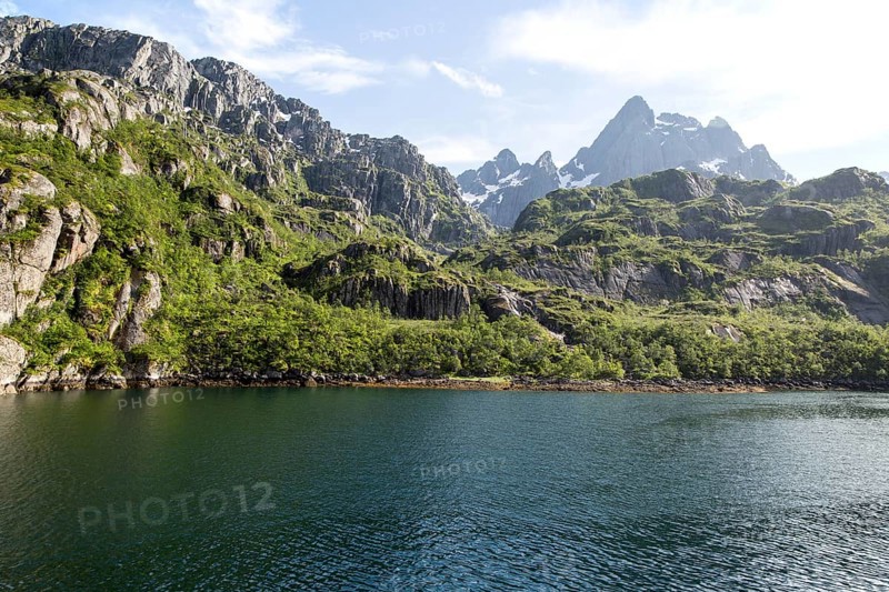 Steep sided glacial trough fiord jagged mountain peaks, Trollfjorden, Lofoten Islands, Nordland, northern, Norway, Europe