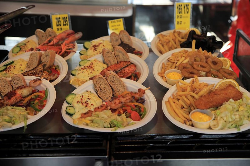Sample street stall restaurant display fish meals in Torget market, Bergen, Norway, Europe