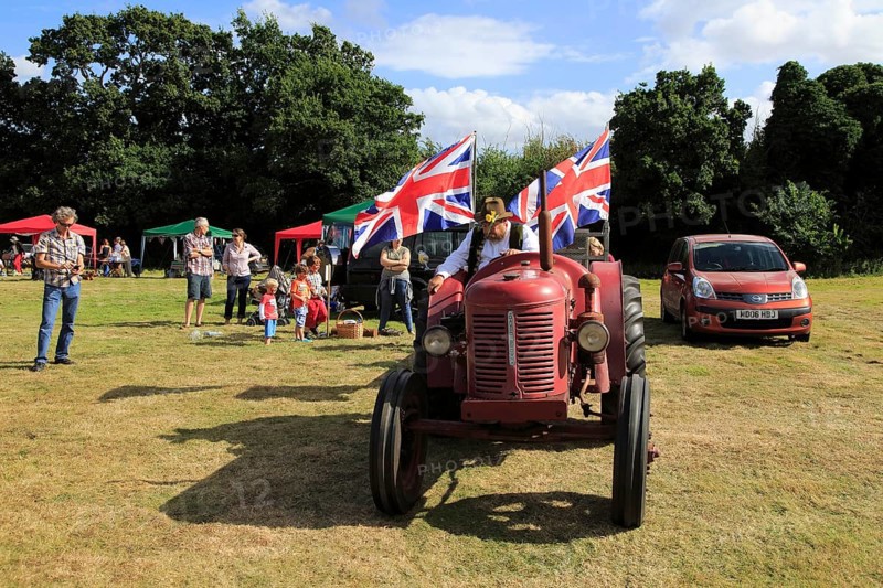 Vintage David Brown tractor giving rides, Sweffling village summer fete, Suffolk, England, UK