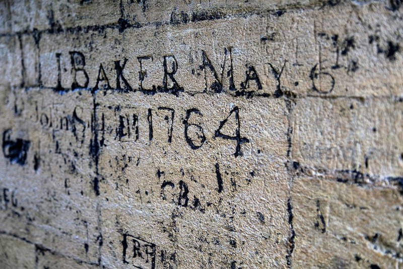 Old graffiti names carved on wall, University Church of St Mary the Virgin, Oxford, England, UK