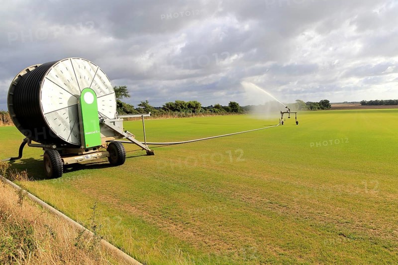 Rainstar irrigator crop sprayer field of grass turf, Alderton, Suffolk, England, UK