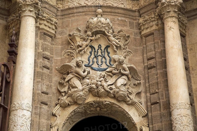 Ornately carved decorated stonework above the entrance to the cathedral church in city of Valencia, Spain, Europe