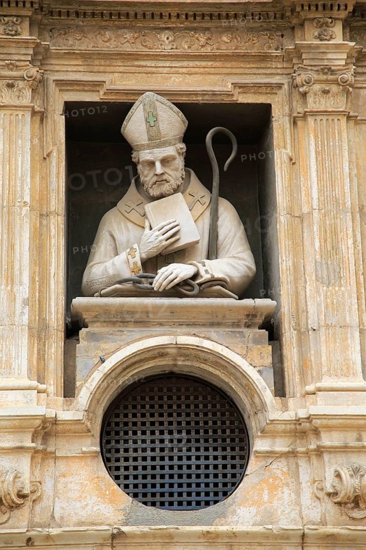 Statue of Christian bishop carved stonework of the cathedral church building in city of Valencia, Spain, Europe