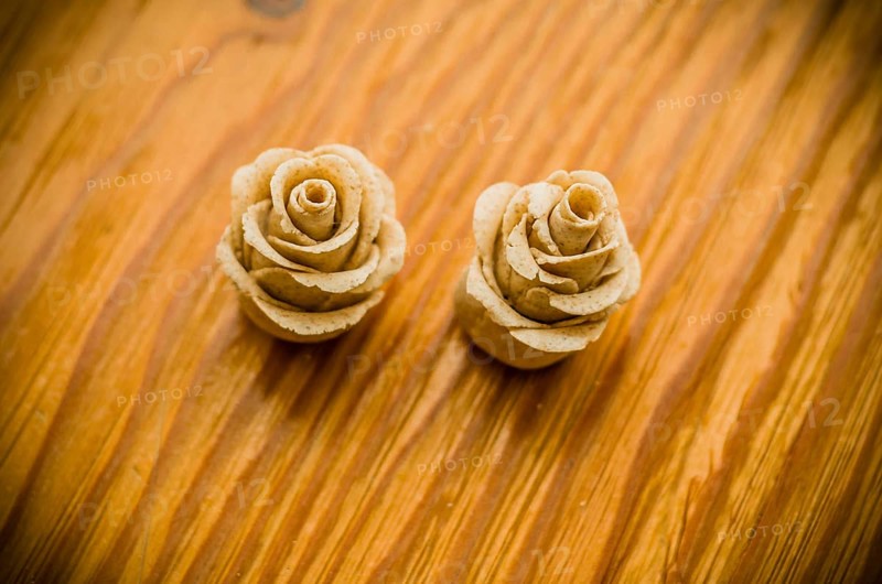 Closeup of rose patterns beige dough sculpture, Teig, gebacken