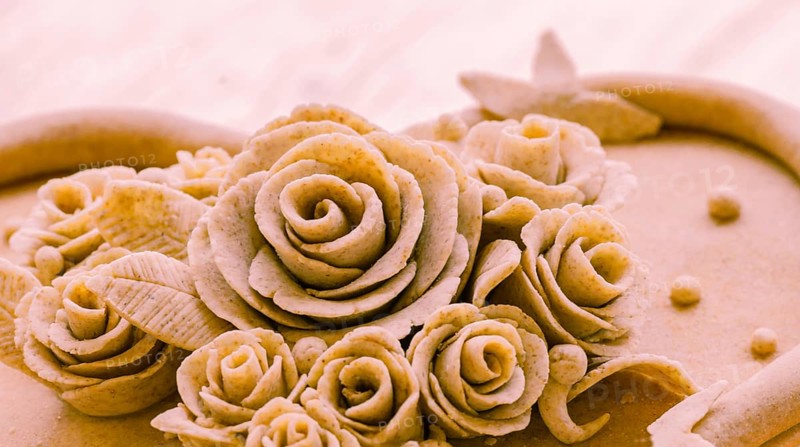 Closeup of rose patterns beige dough sculpture, Teig, gebacken