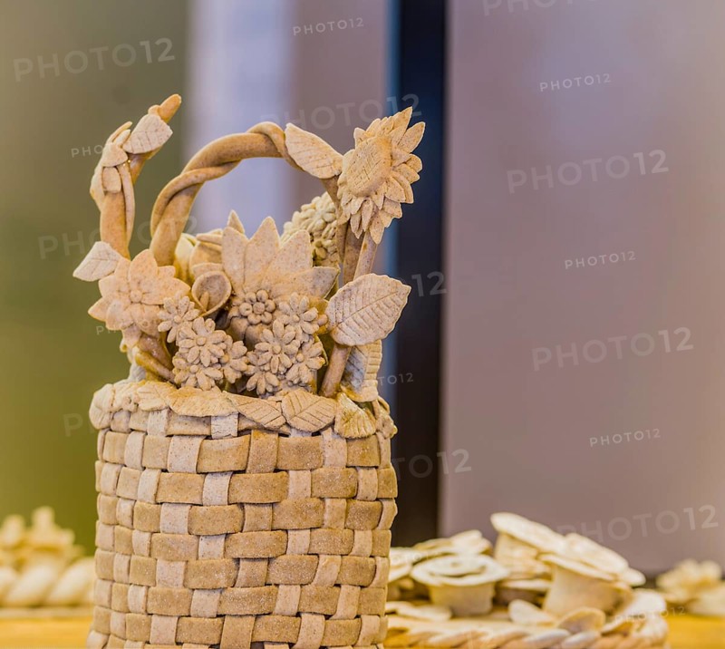Intricate bread basket adorned with detailed flowers and leaves