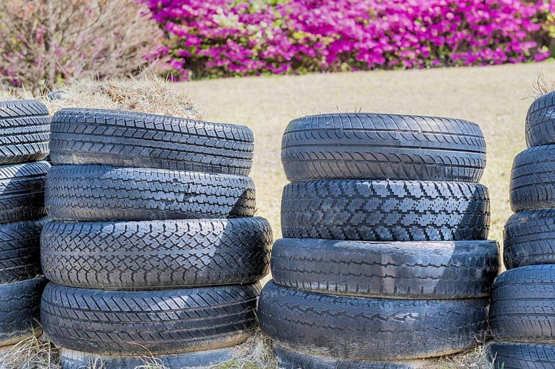 Stacks of old used tires in park with blurred background in Goseong, South Korea, Asia