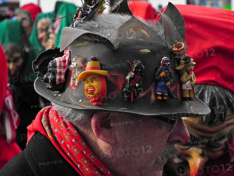 Masks on the hat of a spectator of the parade of the Swabian-Alemannic carnival in Villingen-Schwenningen, Baden-Württemberg, Germany, Europe