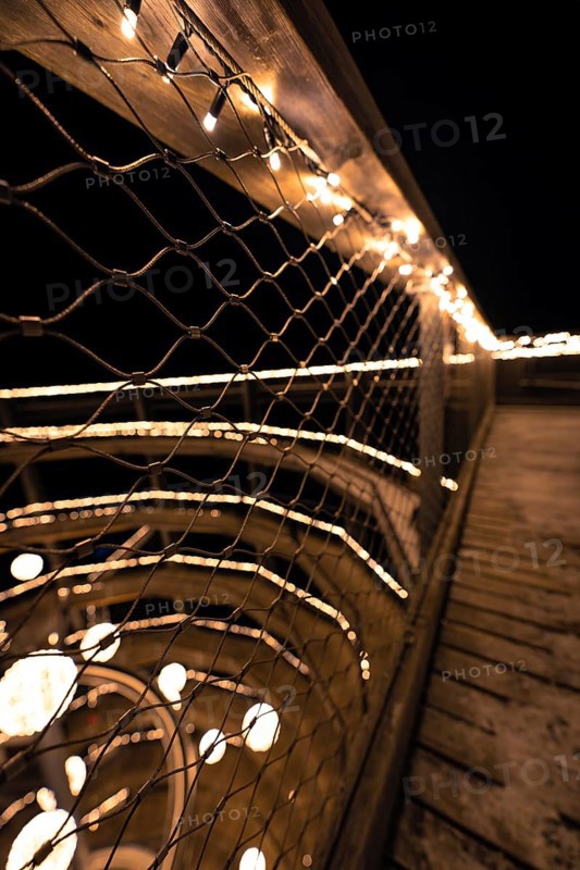 A railing covered with a net of lights against a nocturnal background, Enchanting forest dwellers, Treetop Walk Bad Wildbad, Black Forest, Germany, Europe