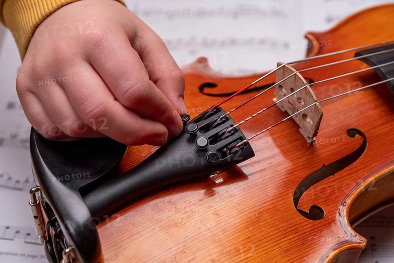 Children's hand tuning viola on the fine tuners, studio recording, Germany, Europe