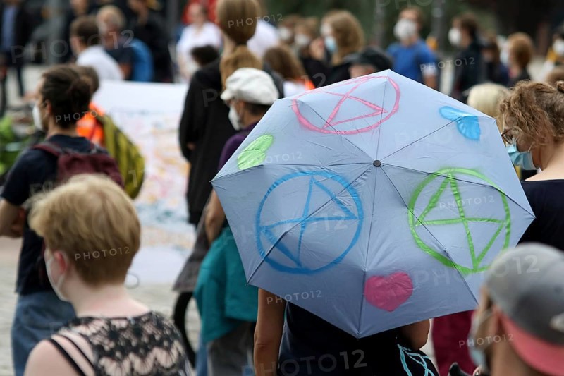 Demonstrators with umbrella with logos of the group Extinction Rebellion at the alliance demo on climate racism and climate flight, with Fridays For Future, Extinction Rebellion, Sea-Watch, Sea-Eye, Seebrücke, Omas gegen Rechts in Hamburg, Germany, among others, Europe