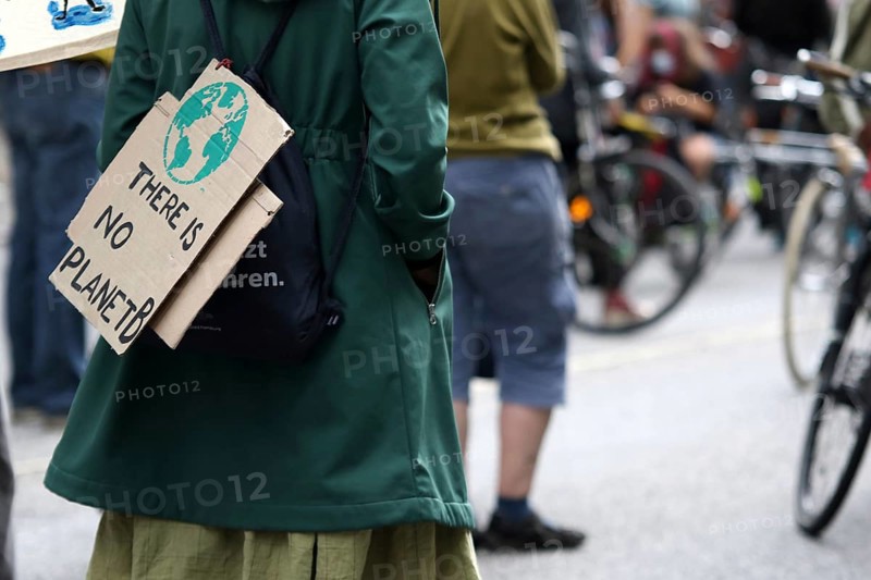 Demonstrator with sign saying There is no planet B at the alliance demo on climate racism and climate flight, with Fridays For Future, Extinction Rebellion, Sea-Watch, Sea-Eye, Seebrücke, Omas gegen Rechts in Hamburg, Germany, among others, Europe