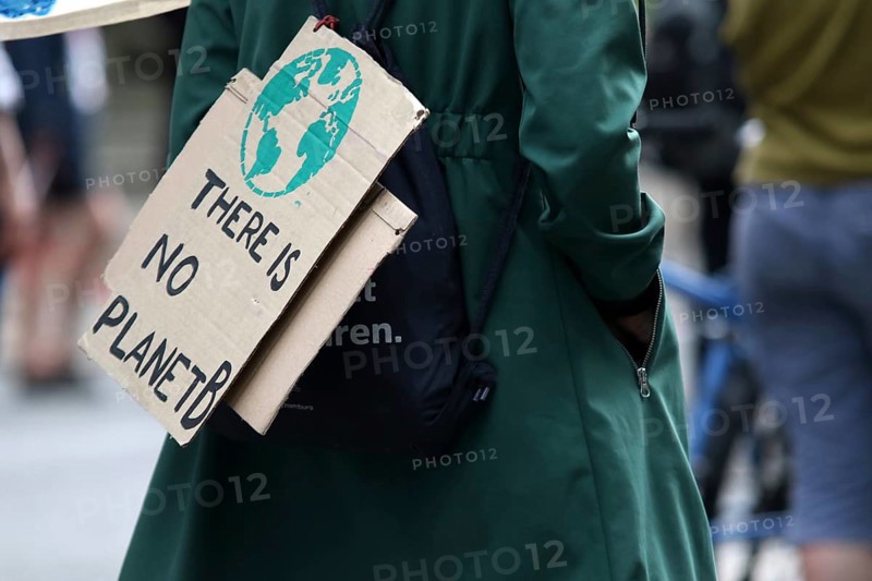 Demonstrator with sign saying There is no planet B at the alliance demo on climate racism and climate flight, with Fridays For Future, Extinction Rebellion, Sea-Watch, Sea-Eye, Seebrücke, Omas gegen Rechts in Hamburg, Germany, among others, Europe
