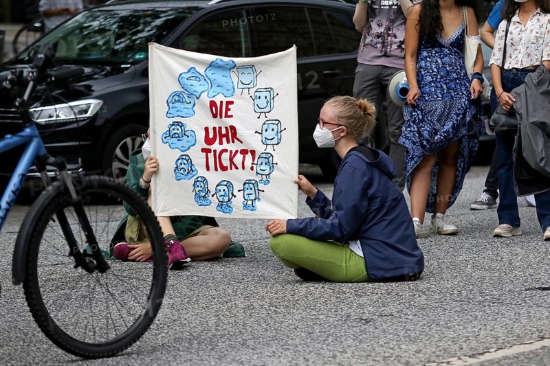 Demonstrators hold a banner with the inscription The clock is ticking! at the alliance demo on climate racism and climate flight, with Fridays For Future, Extinction Rebellion, Sea-Watch, Sea-Eye, Seebrücke, Omas gegen Rechts in Hamburg, Germany, among others, Europe