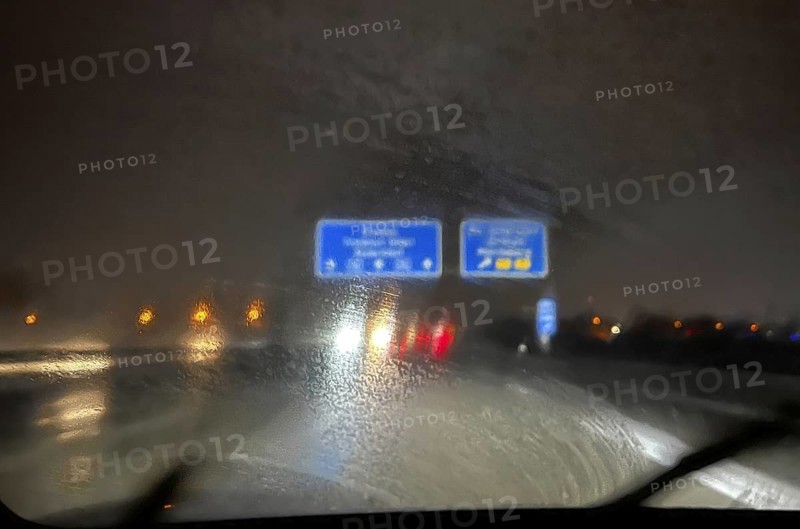A dirty windscreen and old windscreen wipers obstruct visibility on the motorway