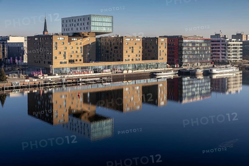 Design hotel nhow, next to Coca-Cola Germany in a red building, reflection of the Spree, former eastern harbour, Friedrichshain-Kreuzberg, Berlin, Germany, Europe