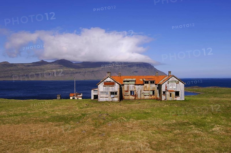 Old abandoned hospital building at the mouth of Faskrudfjordur in the East Fjords region of eastern Iceland