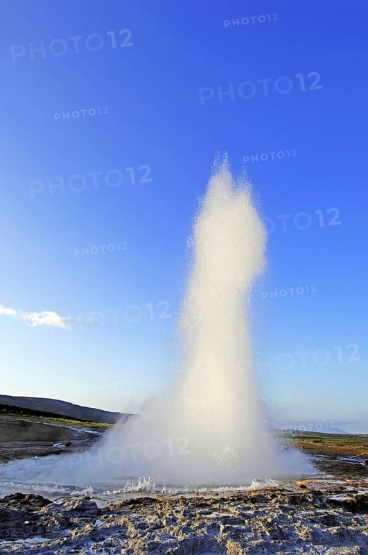 The geyser Strokkur fires steam and boiling water up to a height of around 20m, at Storr Geysir, Haukadalur, south-central Iceland