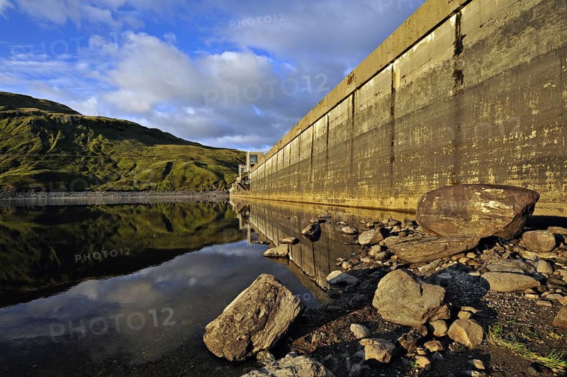 Hydro-electric dam and reservoir in Glen Lyon with pebbled shore and distant ridgeline, Glen Lyon, Perthshire, Scotland, UK