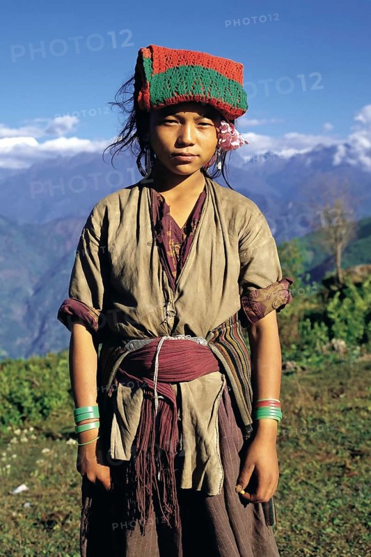 Bhote girl working as a porter in the Arun river district of east Nepal. The pad of material on her forehead is to cushion the tump-line which supports her massive load
