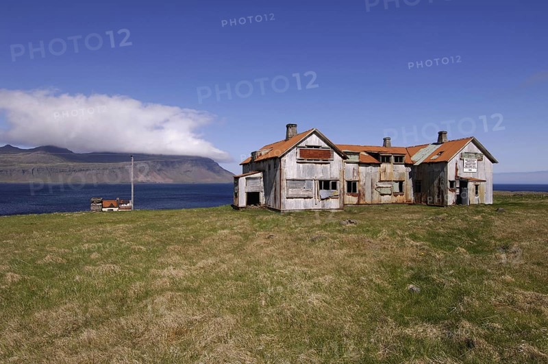 Old abandoned hospital building at the mouth of Faskrudfjordur in the East Fjords region of eastern Iceland