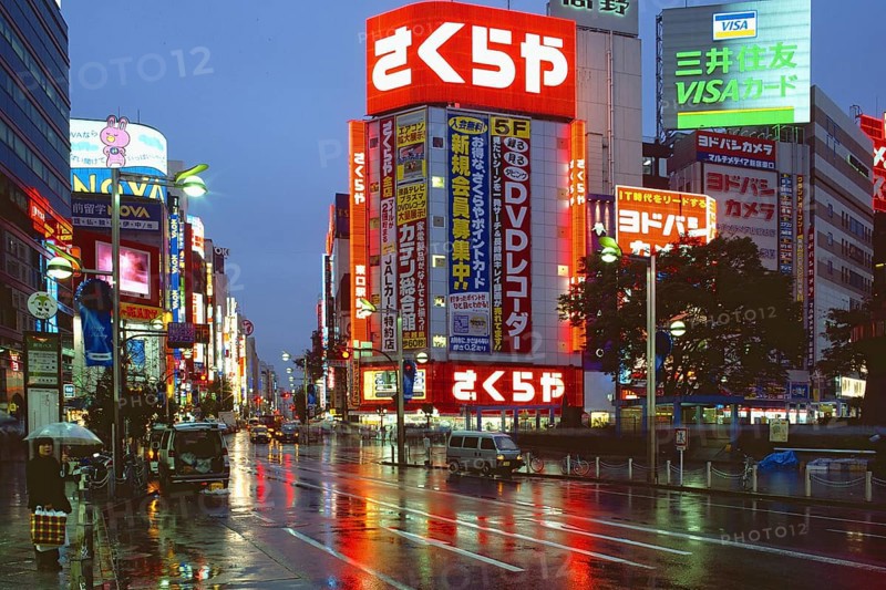 Neon-lit highrise buildings on a wet evening in Shinjuku entertainment district, Tokyo, Japan, Asia