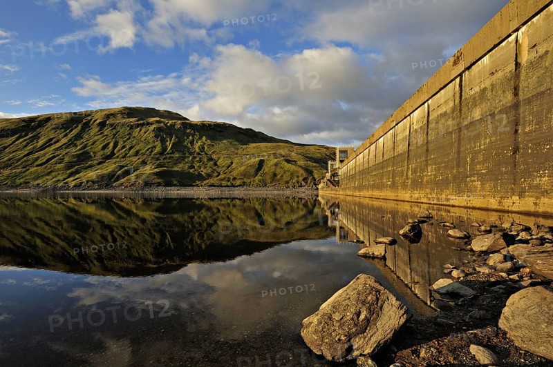 Hydro-electric dam and reservoir in Glen Lyon with pebbled shore and distant ridgeline, Glen Lyon, Perthshire, Scotland, UK