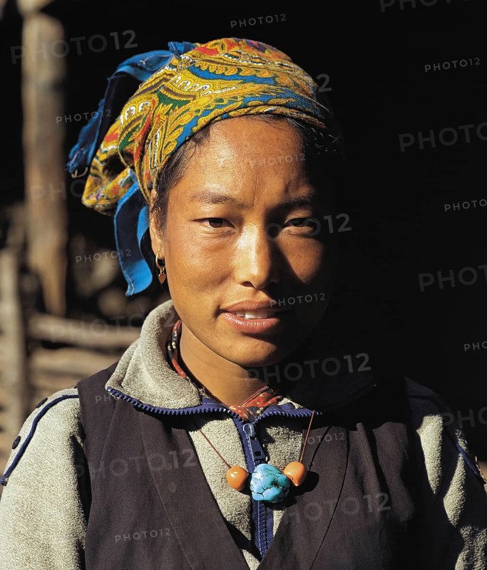 Portrait of pretty Bhotia girl with headscarf at the village of Chhinga in the Mustang region of west Nepal