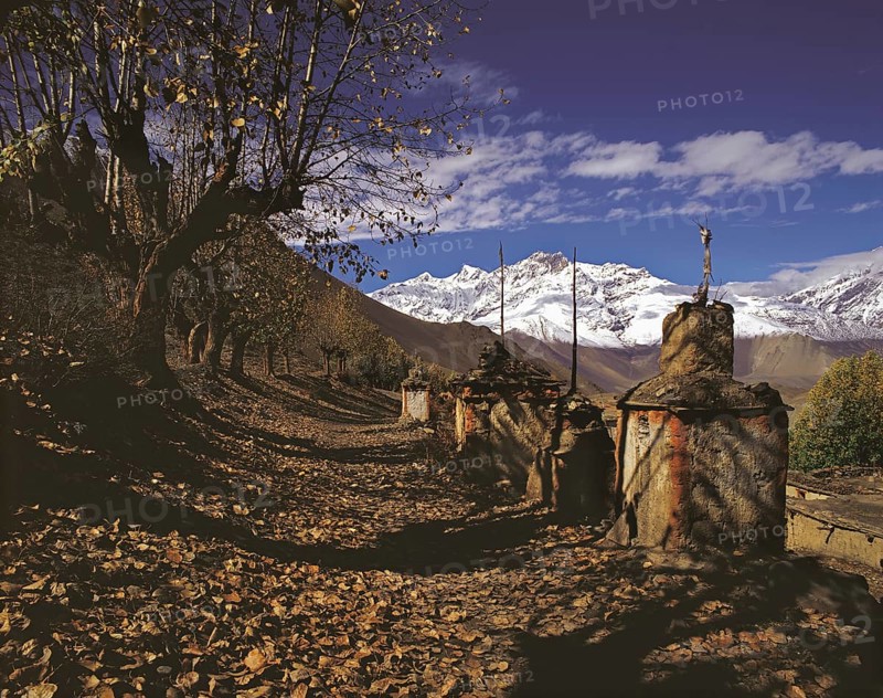 Row of ancient Buddhist devotional objects or chortens with the northern part of the Dhaulagiri Himal behind near Jharkot in the Mustang region of west central Nepal