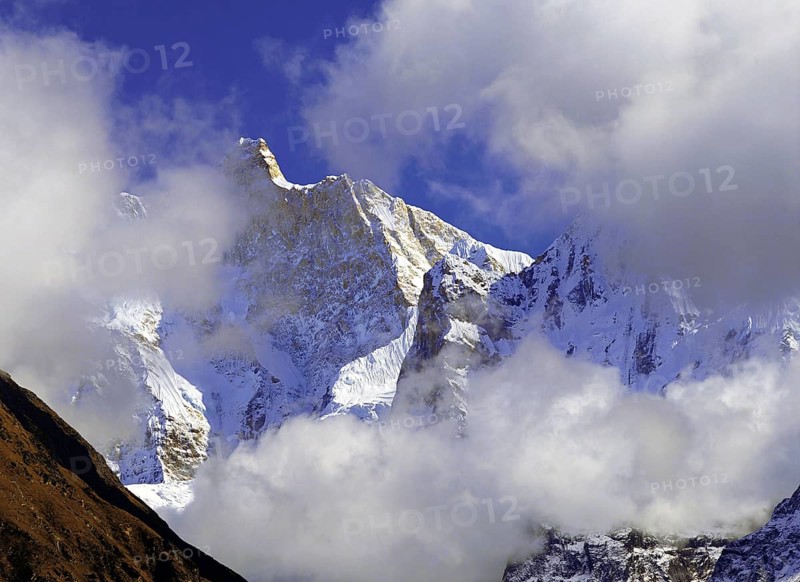 Afternoon mist and clouds gather around the dramatic peak of Jannu in the Kangchenjunga region of east Nepal