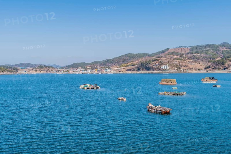 Floating docks loaded with fishing gear in water off island coastal seaport in Yeosu, South Korea, Asia