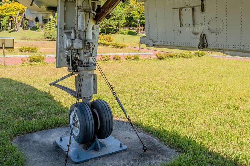 Front landing gear and bay door on jet fighter on display in public park