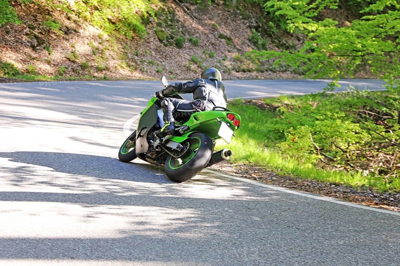 Sporty motorcyclist on a trip into the countryside (Edenkoben Valley, Palatinate Forest)