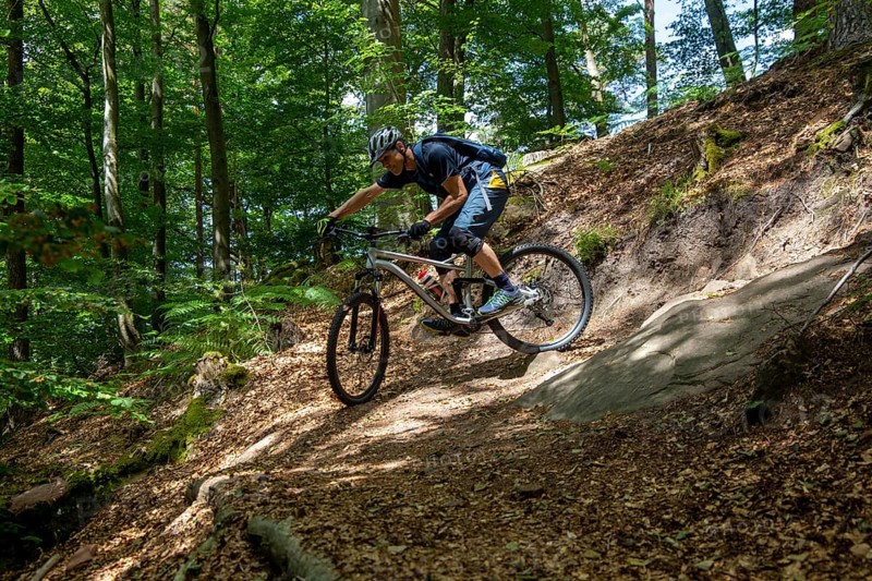 Mountain biker negotiates a tight hairpin bend in the Pfaelzerwald mountain bike park near Dahn