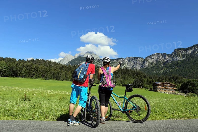Mountain bikers enjoy the panorama from the Wilder Kaiser